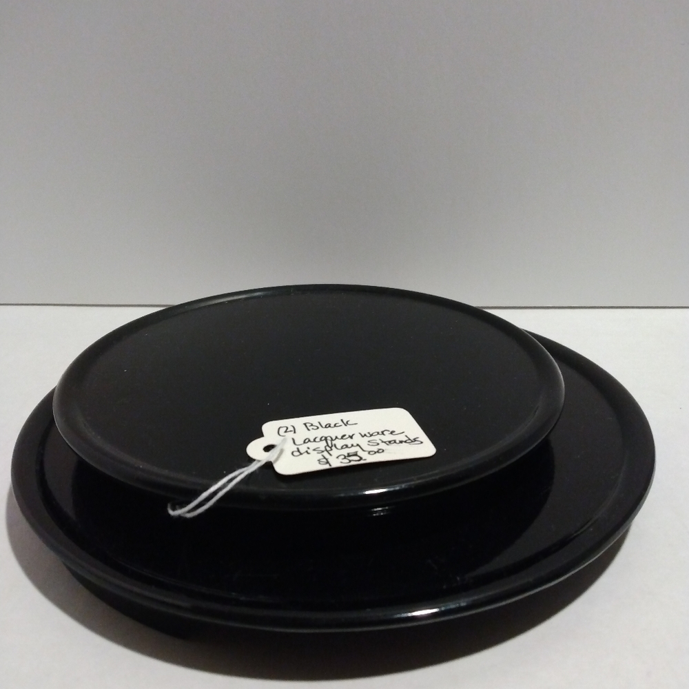 2 Vtg black lacquer round footed display stands. Mid Century.